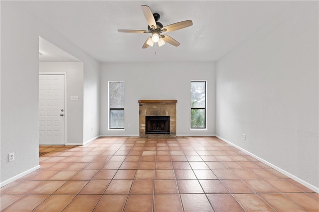 unfurnished living room with light tile patterned flooring, ceiling fan, and a fireplace