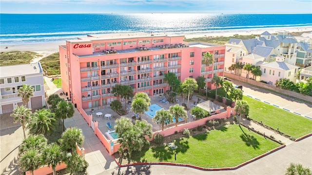 bird's eye view with a water view and a beach view