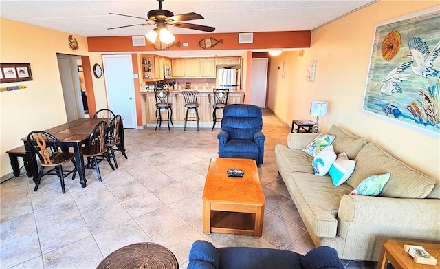 living area with visible vents and ceiling fan