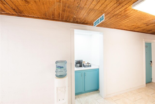 interior space with light tile patterned floors and wood ceiling