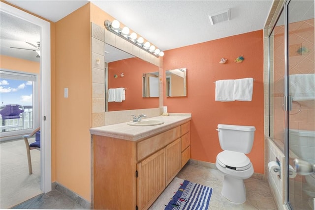 bathroom with a stall shower, visible vents, toilet, a textured ceiling, and vanity