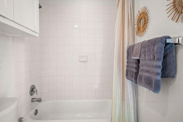 bathroom with toilet and shower / tub combo with curtain