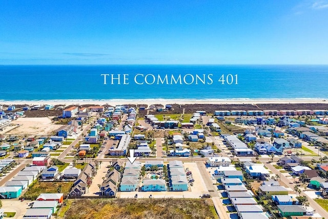 bird's eye view with a residential view, a water view, and a view of the beach