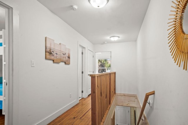 hallway featuring baseboards and light wood finished floors