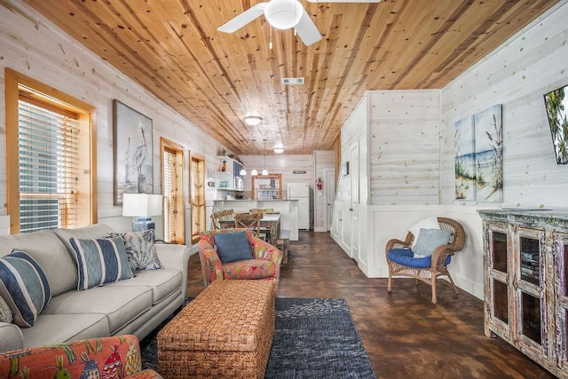 living room featuring finished concrete floors, ceiling fan, wooden ceiling, and visible vents