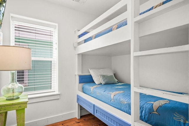 bedroom with wood finished floors and baseboards