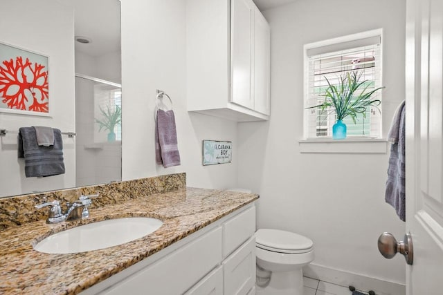 bathroom featuring vanity, baseboards, an enclosed shower, tile patterned floors, and toilet