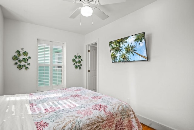 bedroom featuring baseboards and ceiling fan