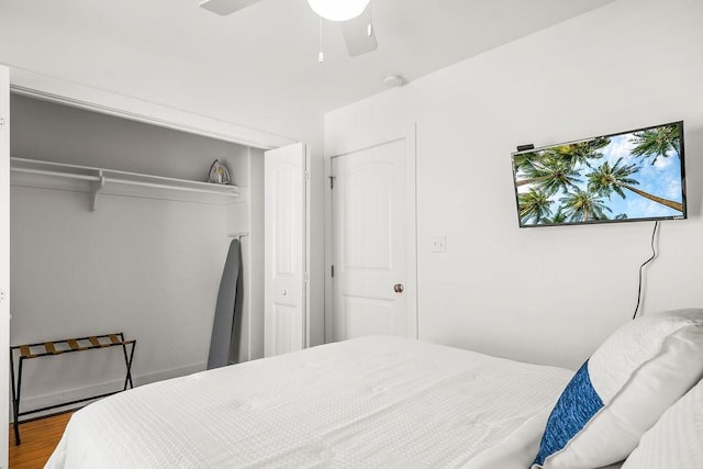 bedroom with a closet, wood finished floors, and a ceiling fan