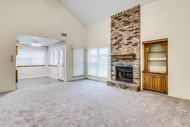 unfurnished living room with high vaulted ceiling, carpet, visible vents, and a fireplace