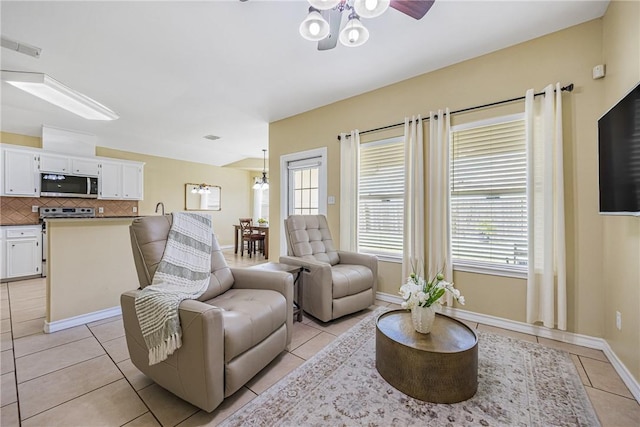 3137 Masterson Dr, Corpus Christi, TX 78415 - living room with light tile patterned floors, a ceiling fan, and healthy amount of natural light