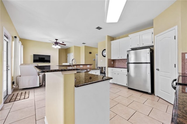 3137 Masterson Dr, Corpus Christi, TX 78415 - kitchen with freestanding refrigerator, ceiling fan, light tile patterned floors, and open floor plan
