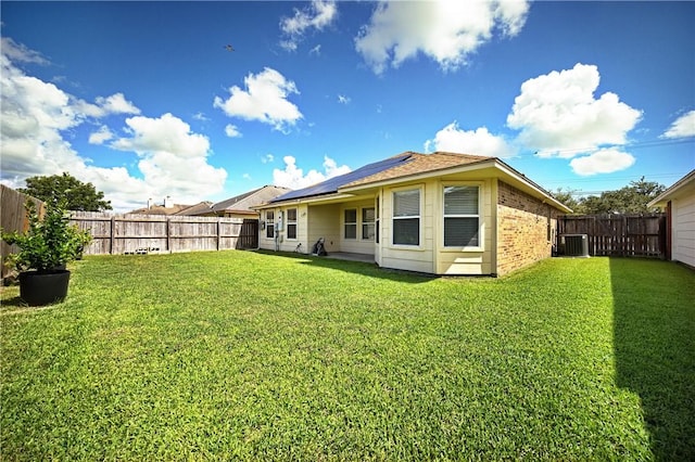 3137 Masterson Dr, Corpus Christi, TX 78415 - back of property featuring solar panels, a fenced backyard, and brick siding