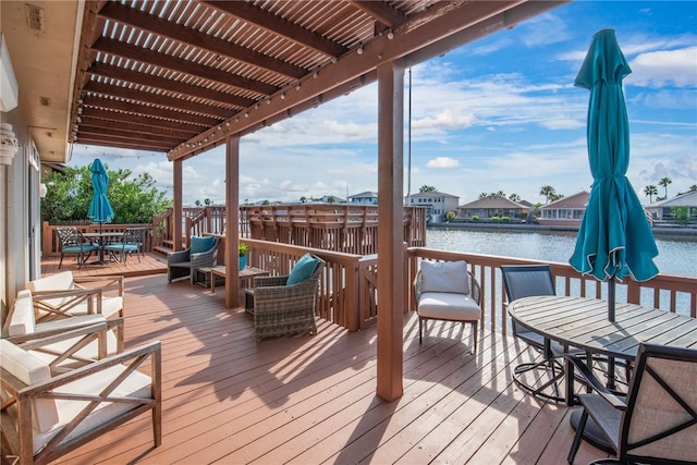 wooden terrace featuring a water view