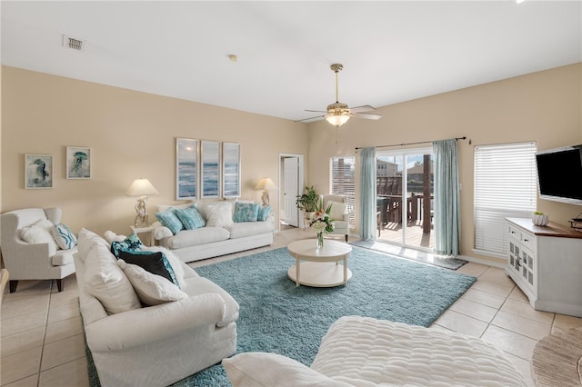 living room featuring light tile patterned floors and ceiling fan