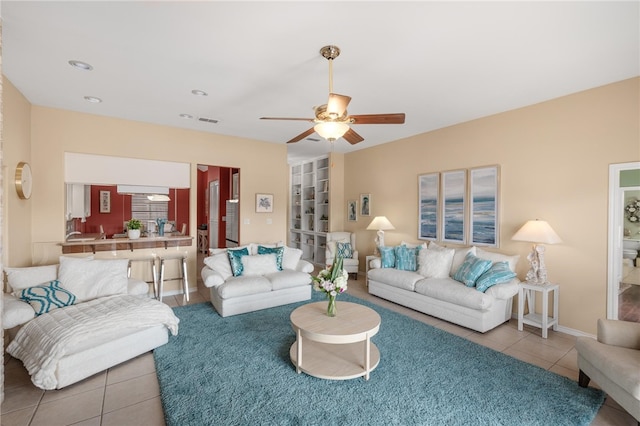 tiled living room featuring ceiling fan