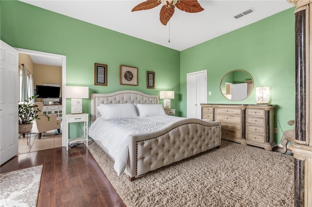 bedroom with dark hardwood / wood-style flooring, a closet, and ceiling fan