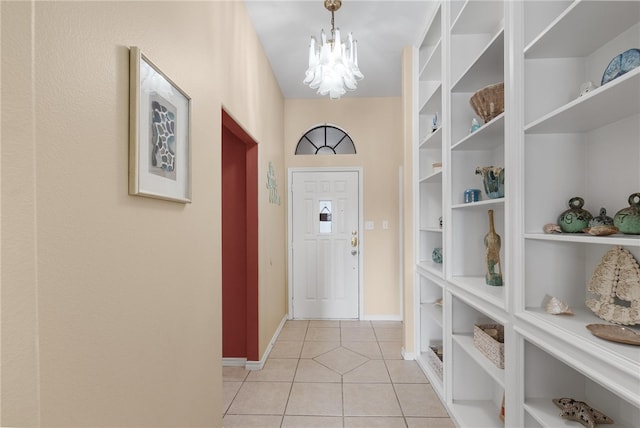 doorway featuring a chandelier and light tile patterned floors