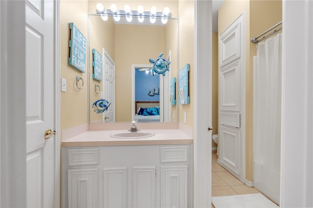 bathroom with vanity, tile patterned flooring, and toilet