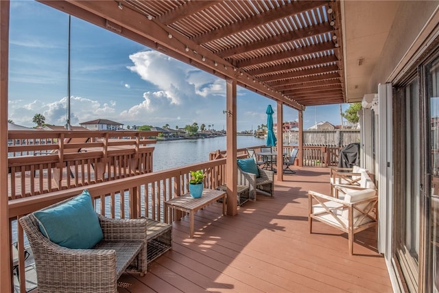 wooden deck featuring a water view and a pergola