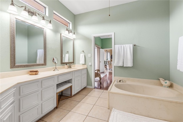 bathroom featuring vanity, tile patterned floors, and a bathing tub