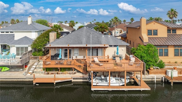 rear view of house with a deck with water view