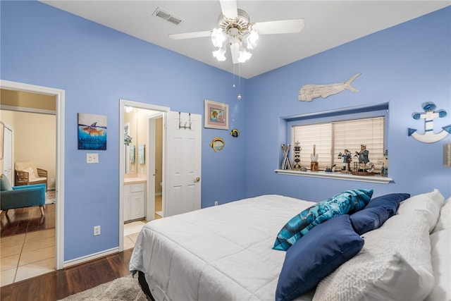 bedroom featuring wood-type flooring, ceiling fan, and ensuite bathroom