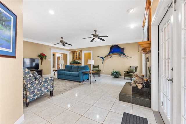 tiled living room featuring ceiling fan and ornamental molding