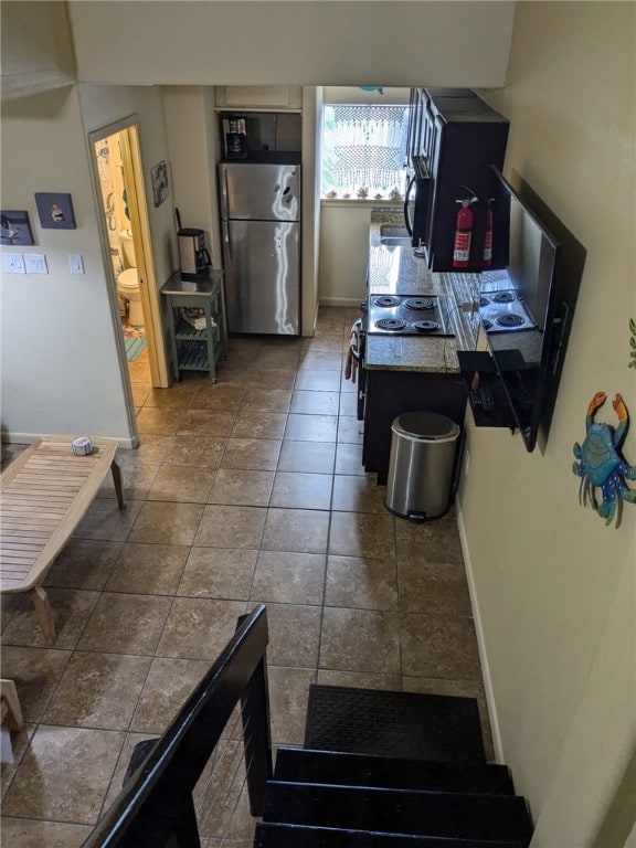 14300 S Padre Island Dr Unit 223, Corpus Christi, TX 78418 - kitchen with freestanding refrigerator and baseboards