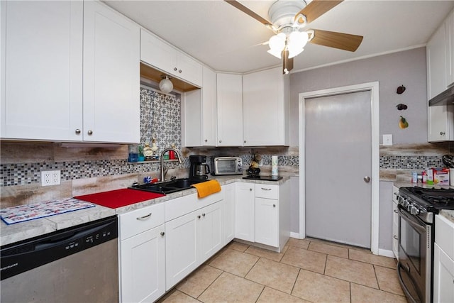 kitchen with appliances with stainless steel finishes, white cabinetry, decorative backsplash, and sink