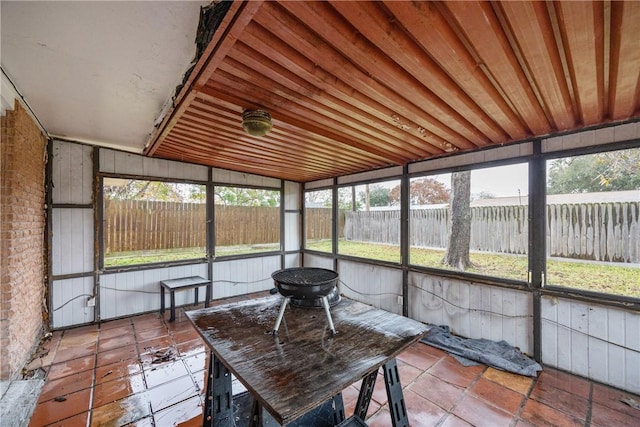 unfurnished sunroom featuring wooden ceiling