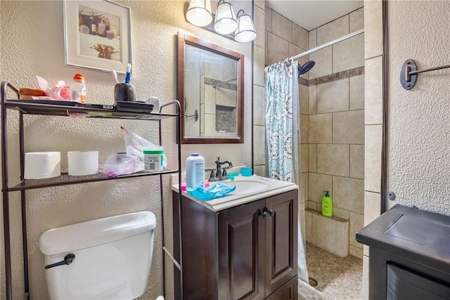 bathroom with toilet, a shower with shower curtain, and vanity