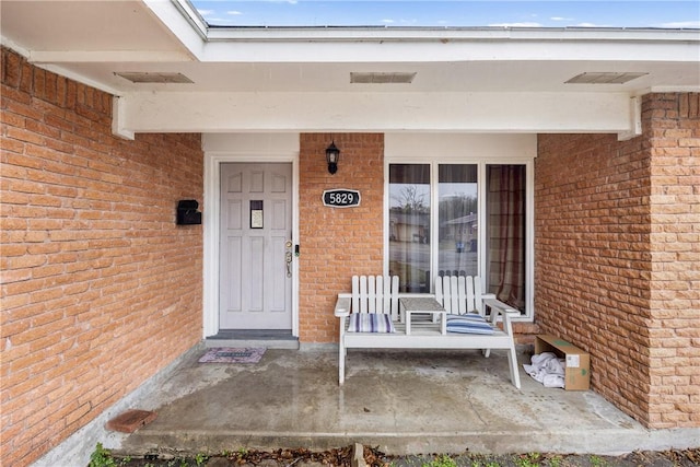 doorway to property featuring covered porch