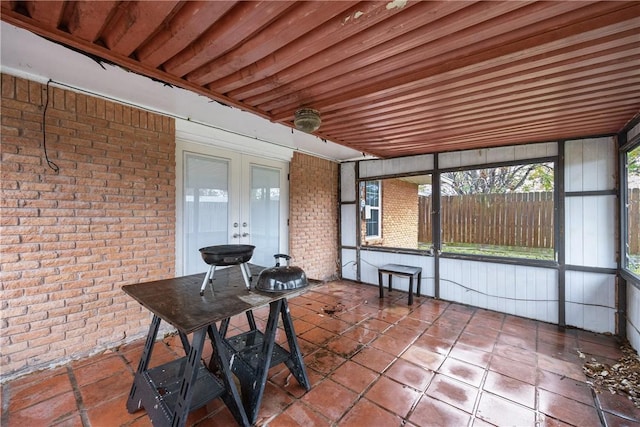 unfurnished sunroom with french doors