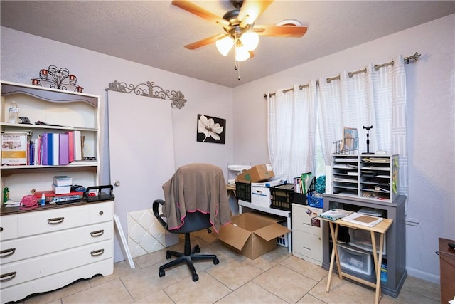 tiled office featuring a textured ceiling and ceiling fan