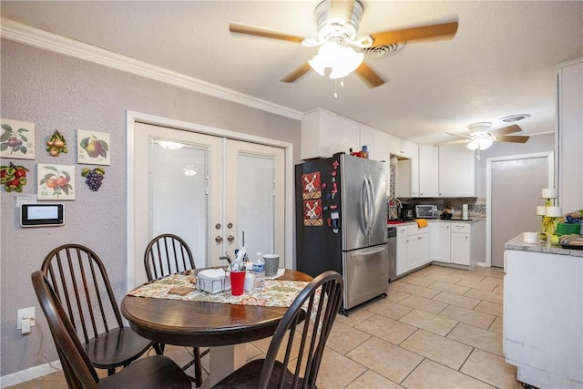 tiled dining area with french doors and crown molding