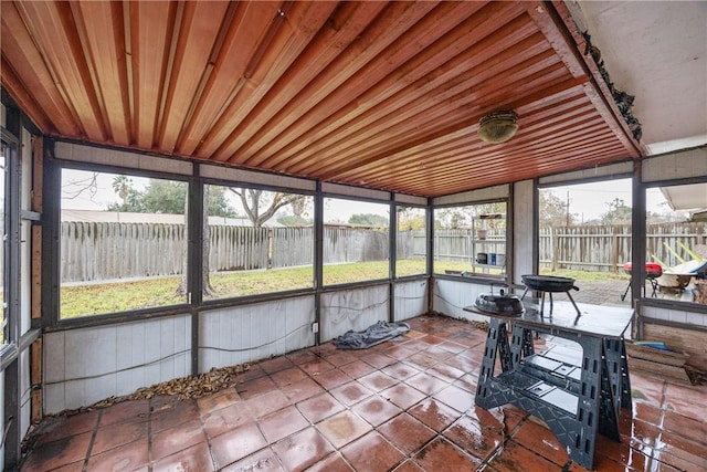 unfurnished sunroom featuring wooden ceiling