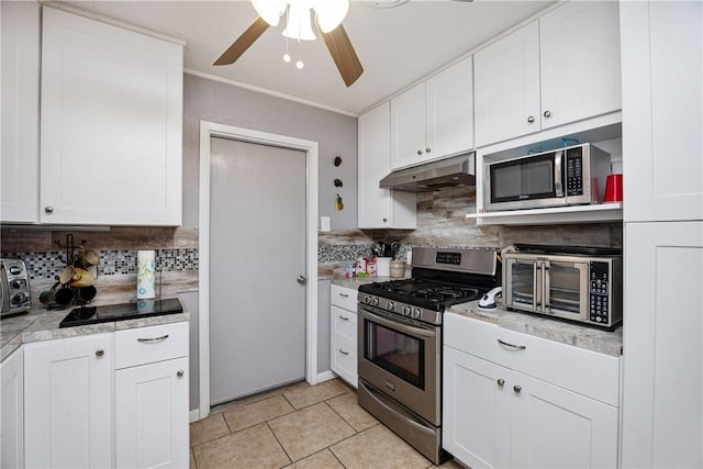 kitchen featuring white cabinets, light tile patterned flooring, tasteful backsplash, and appliances with stainless steel finishes