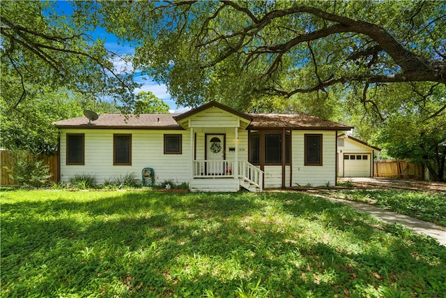 ranch-style house with a garage, a front yard, and a porch