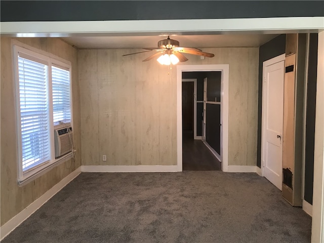 empty room with cooling unit, dark colored carpet, and ceiling fan