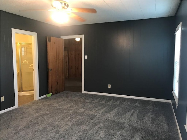 1222 18th St, Corpus Christi, TX 78405 - unfurnished bedroom featuring carpet floors, ensuite bathroom, multiple windows, and a ceiling fan
