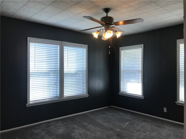 carpeted empty room featuring ceiling fan