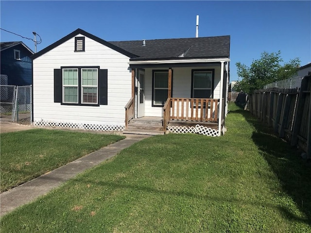 1222 18th St, Corpus Christi, TX 78405 - bungalow featuring covered porch, a fenced backyard, and roof with shingles