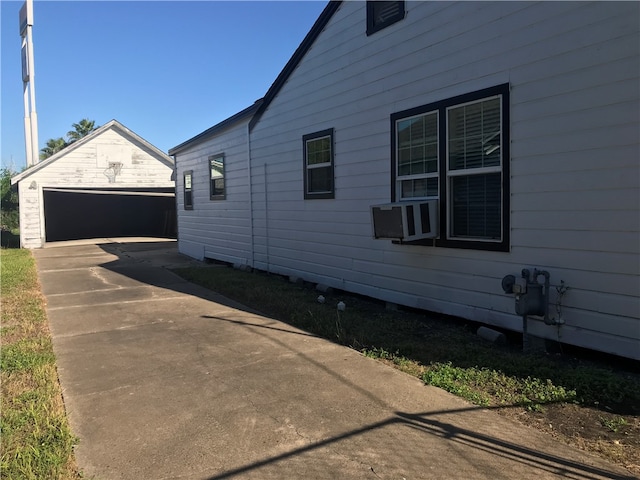 view of side of home with a garage and an outbuilding