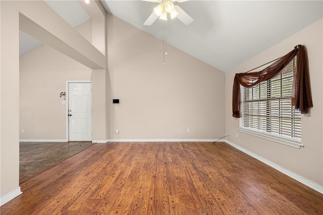 empty room featuring ceiling fan, high vaulted ceiling, wood finished floors, and baseboards