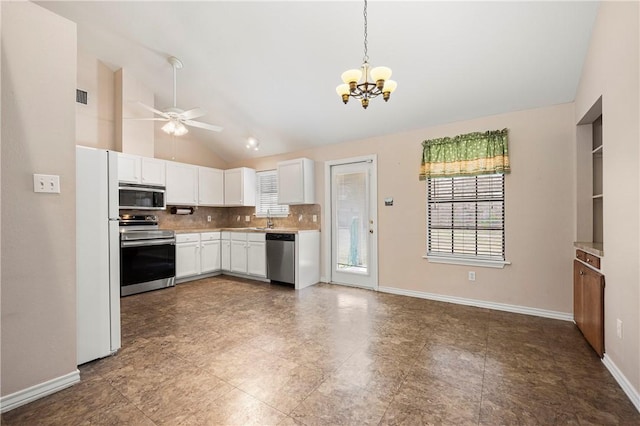 kitchen with stainless steel appliances, light countertops, white cabinetry, pendant lighting, and backsplash