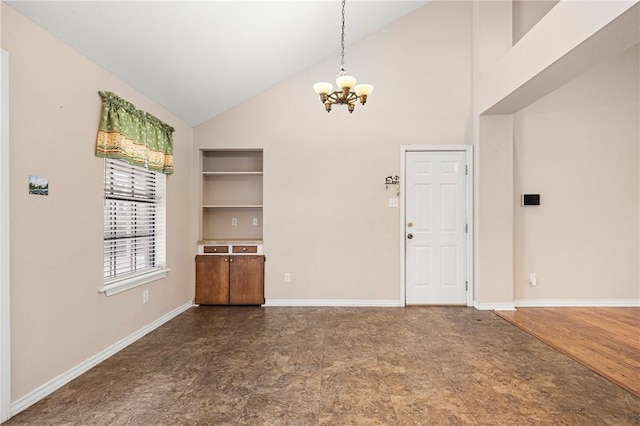 unfurnished dining area featuring high vaulted ceiling, baseboards, and a notable chandelier