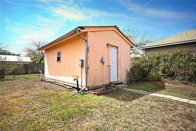 view of outbuilding with fence and an outdoor structure