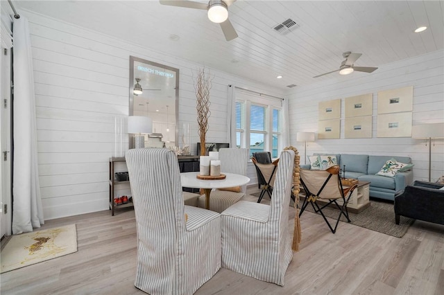 dining area featuring light hardwood / wood-style floors and wooden ceiling