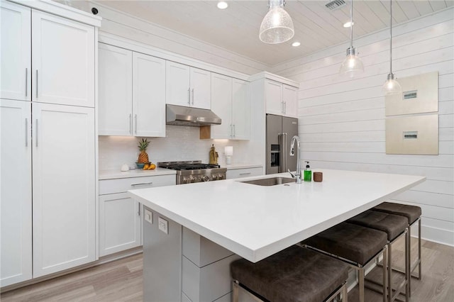 kitchen with white cabinetry and hanging light fixtures